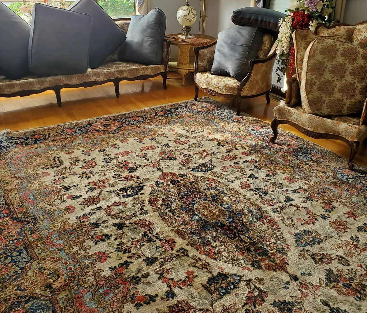 Residential sitting room with upholstered chairs and a patterned area rug