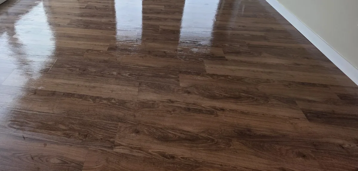 Glossy wood flooring reflecting daylight from nearby windows
